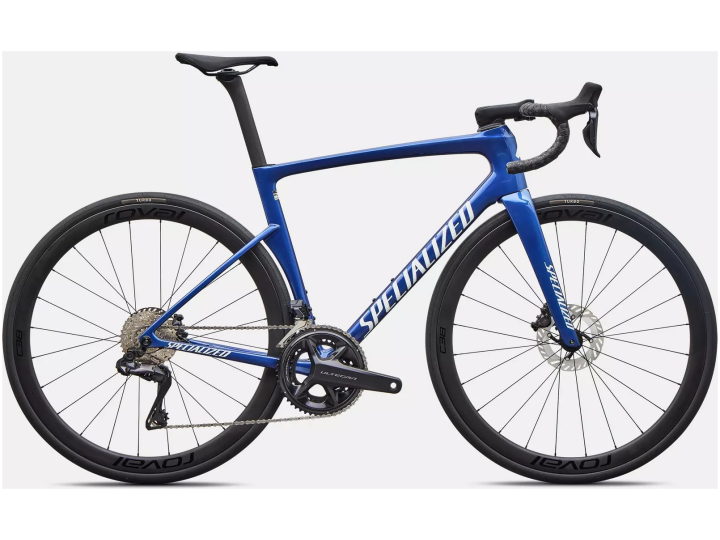 Ein blaues Specialized Tarmac SL9 Expert Rennrad mit Rennlenker, schmalen Reifen und Scheibenbremsen, abgebildet vor einem weißen Hintergrund.